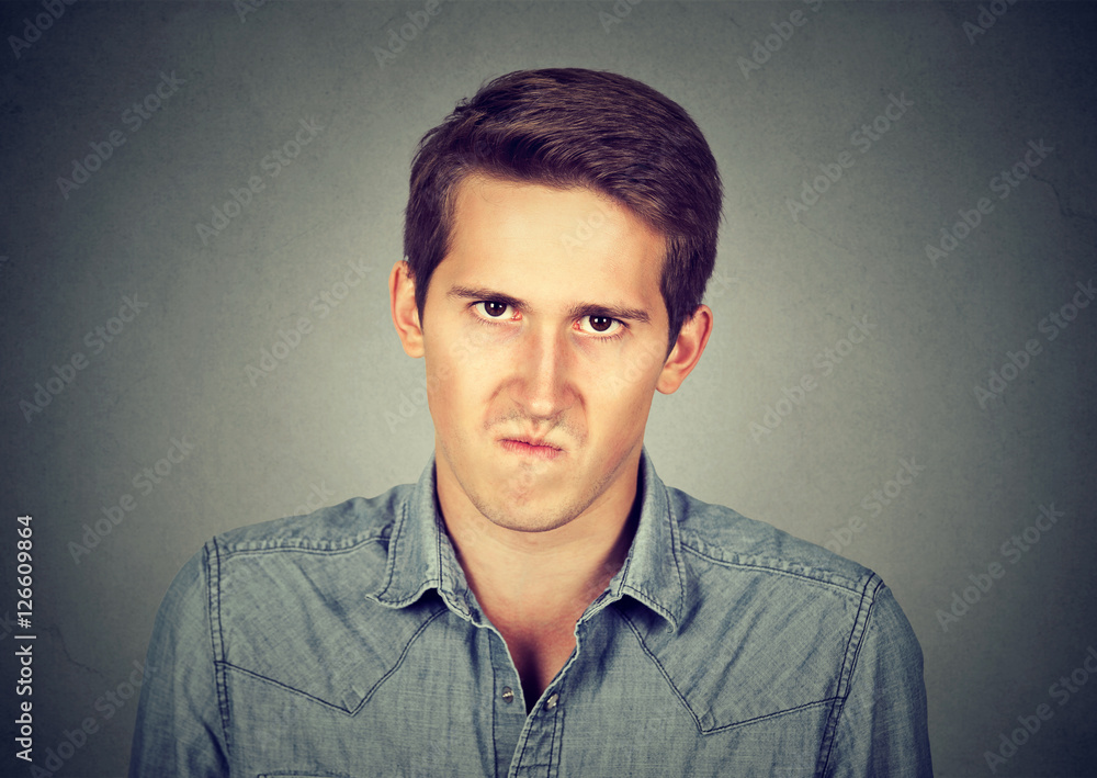 Annoyance. Angry displeased young man StockFoto Adobe Stock