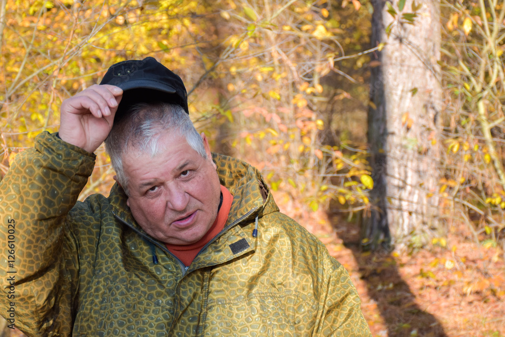 Mature caucasian man lifting a hat Mature caucasian man lifting a hat