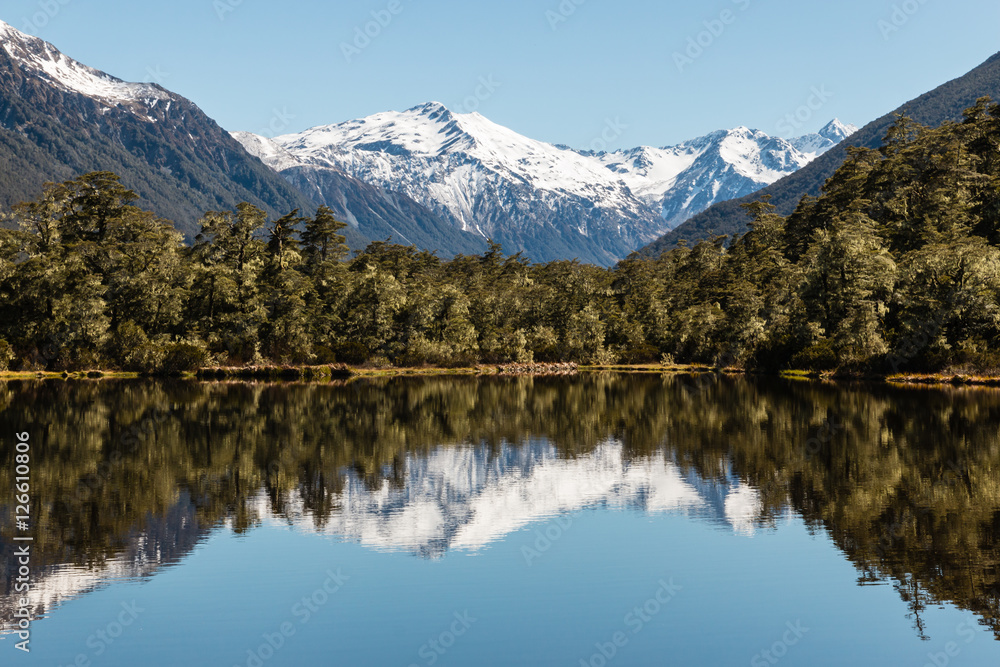mountain range reflecting in lake in Southern Alps near Lewis Pass, New Zealand