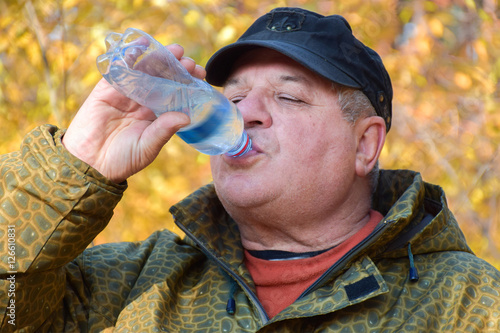 Mature caucasian man with a bottle of water