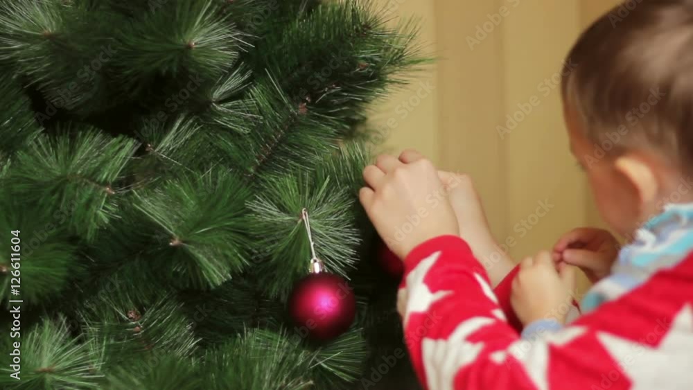Happy family decorates Christmas tree Happy family decorates Christmas tree
