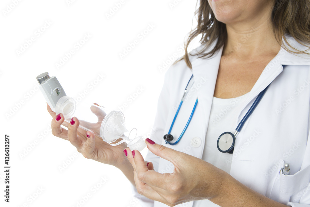 Doctor removes the cap of an aerosol inhaler placed on a space c Doctor removes the cap of an aerosol inhaler placed on a space c