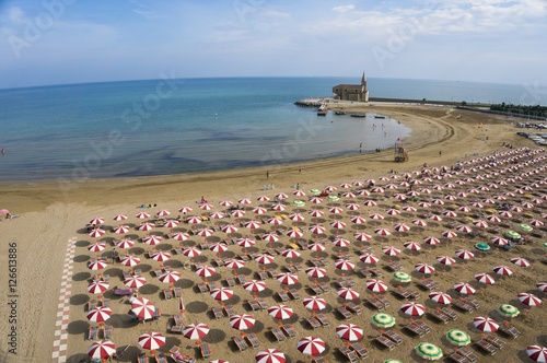 Rows of umbrellas on beach photo