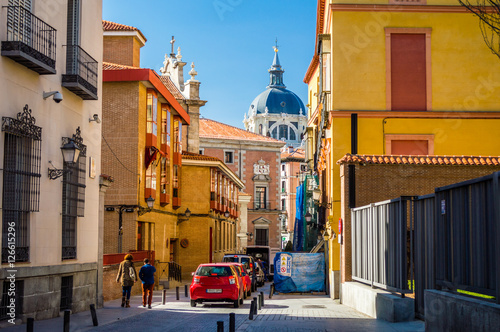 Colorful Madrid street and Almudena Cathedral view in Madrid, Spain