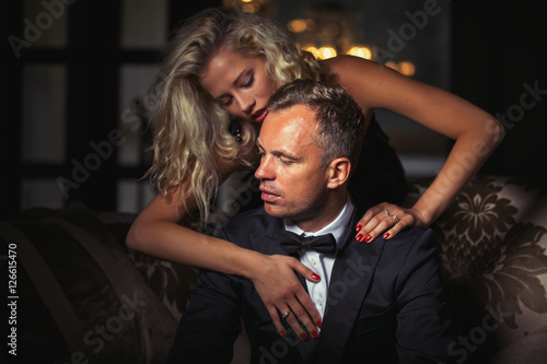 Woman touching man in tuxedo