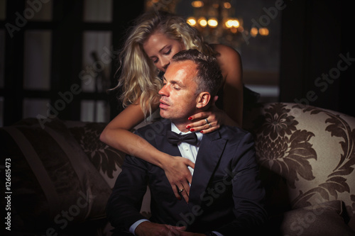 Woman wraping her arms around man