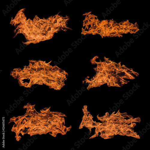 Orange flames on a black background. Isolated photo