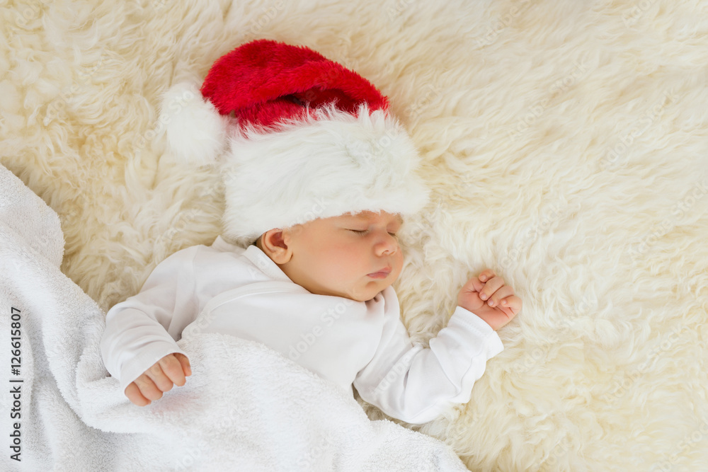 Baby sleeping with Christmas hat on