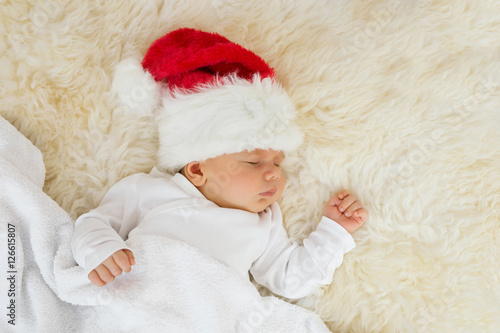 Baby sleeping with Christmas hat on