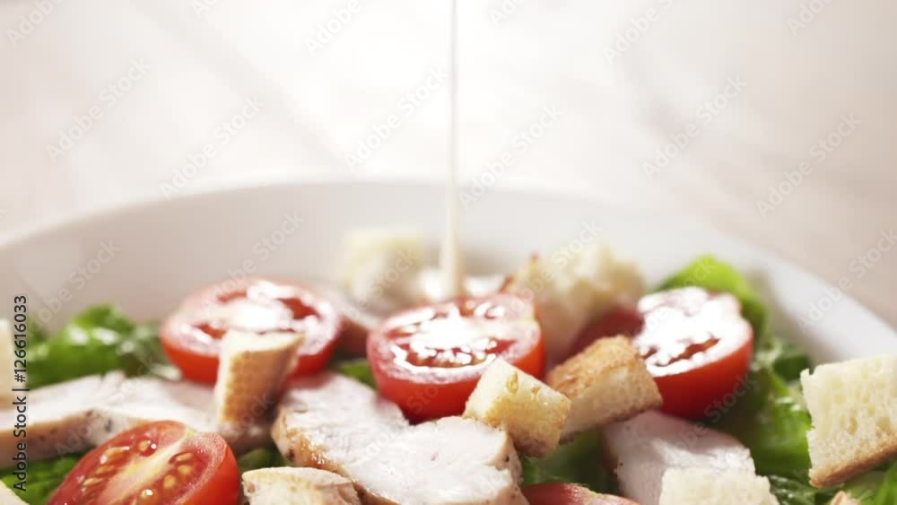 caesar salad closeup handheld follow dressing pour into salad caesar salad closeup handheld follow dressing pour into salad