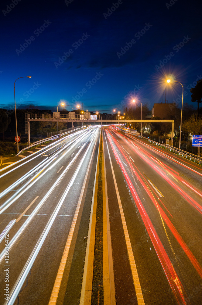 Speed Traffic - light trails on motorway highway at night, long exposure abstract urban background