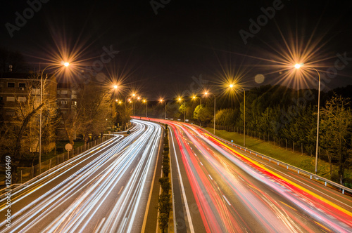 Speed Traffic - light trails on motorway highway at night, long exposure abstract urban background