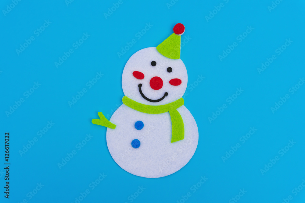 flat smiling toy christmas snowman with green scarf on blue