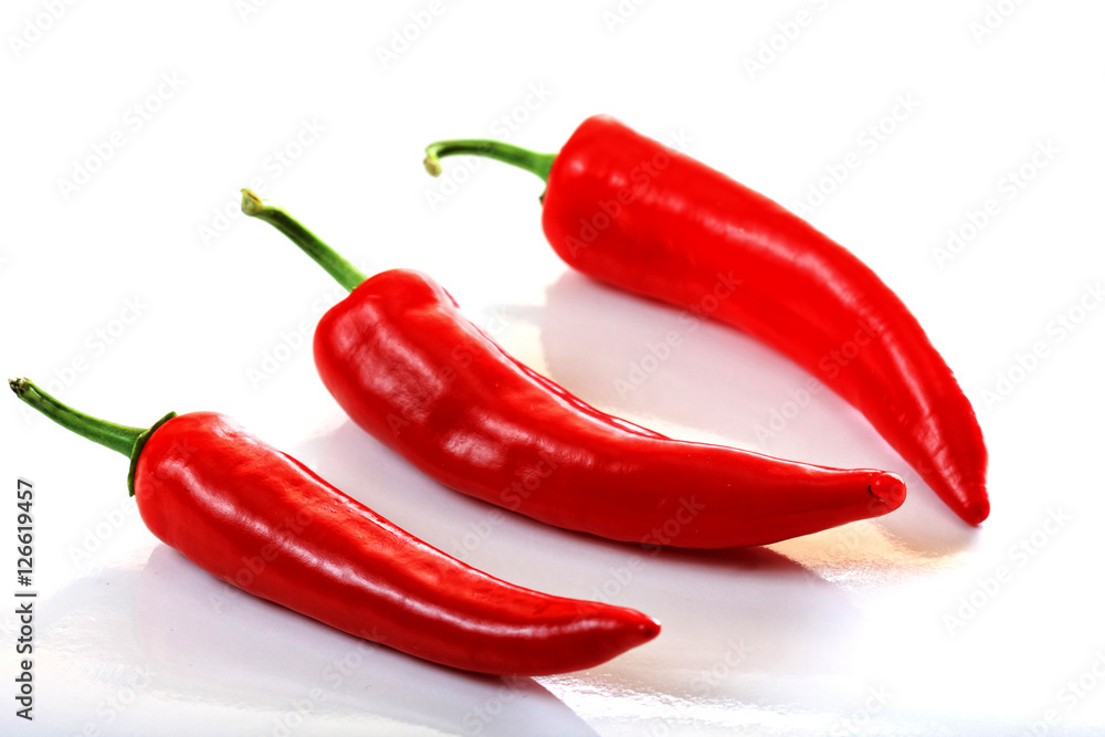 Three peppers on light background