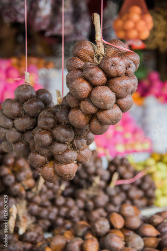 Bunch of ripe Salak hanging in a tent on the Singapore trader photo