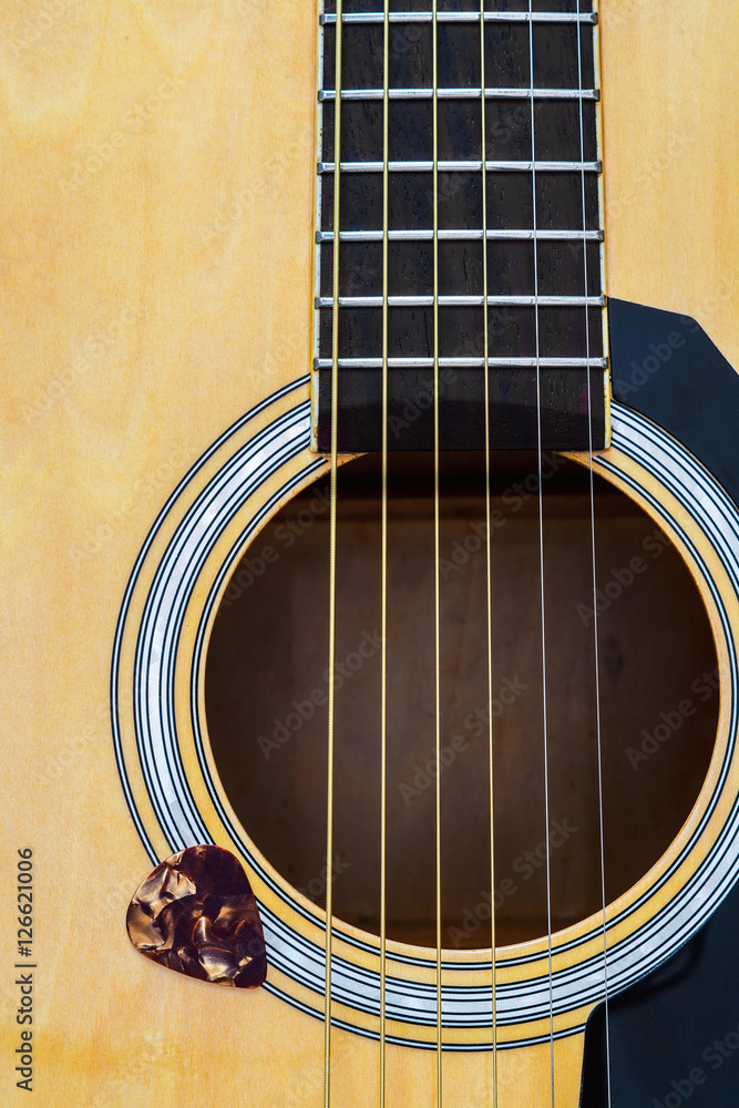 Obraz premium Close up of acoustic guitar with pick