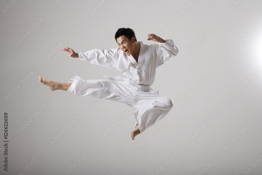 Man doing a flying kick, martial arts