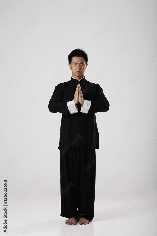 Man meditating wearing traditional Chinese clothes Man meditating wearing traditional Chinese clothes