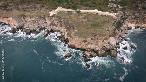 Aerial view of rocky coastline with crop fields photo