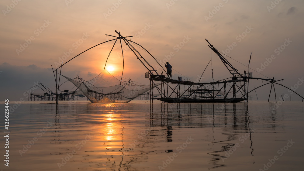 Fisherman with giant square dip net at Pakpra canal, Phatthalung, Thailand.