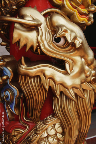 Close up of gold dragon on temple pillar