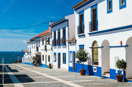 Traditional blue and white Alentejo Portuguese buildings in Porto Covo, Portugal photo