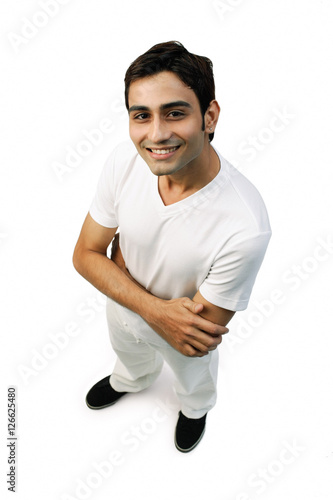 Young man looking up at camera, arms crossed