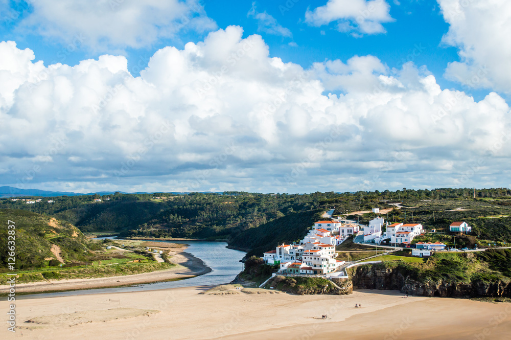 Odeceixe cityscape  - blue sky with clouds and white houses in Odeceixe, Portugal