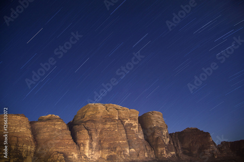 Star trails over desert mountains of Wadi Rum