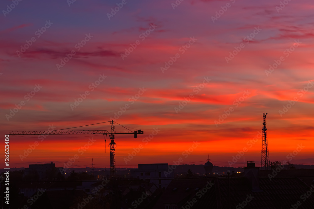 Silhouette of a crane in the city at sunset Silhouette of a crane in the city at sunset