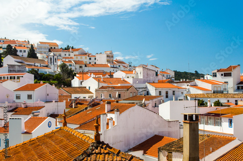 Odeceixe cityscape  - white houses with red roofs and blue sky in Odeceixe, Portugal