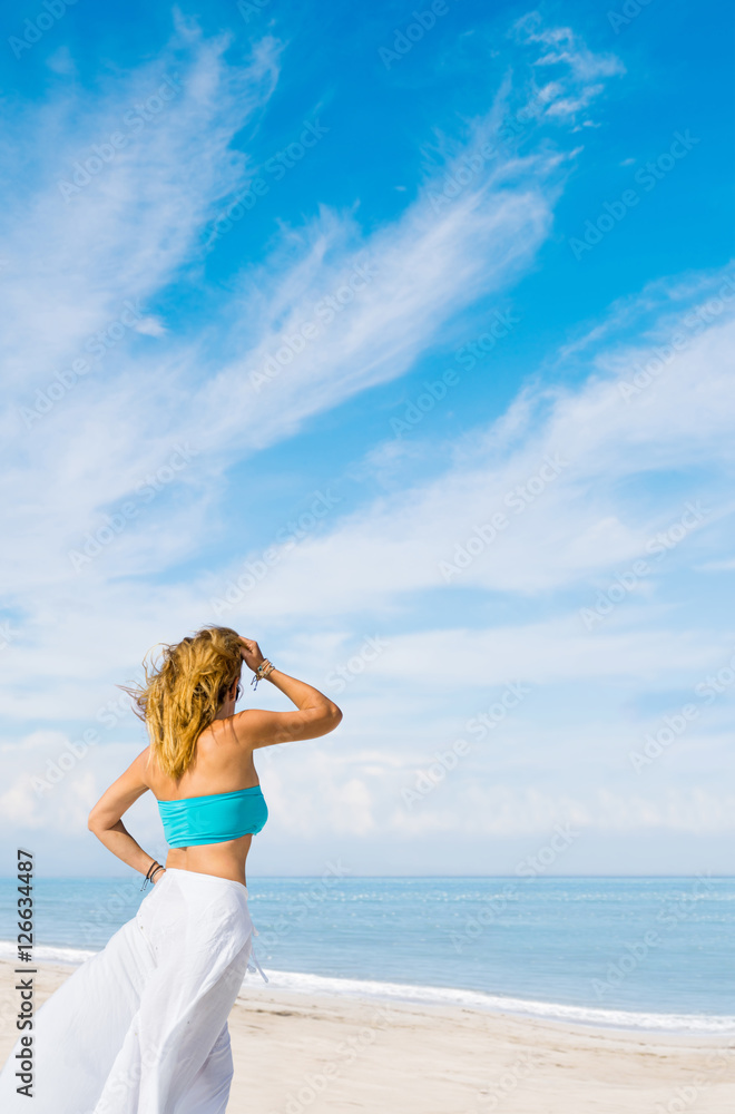 portrait of young pretty woman looking to the ocean portrait of young pretty woman looking to the ocean