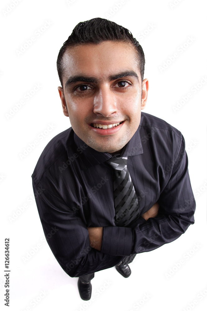 Businessman, arms crossed, looking up at camera, smiling Businessman, arms crossed, looking up at camera, smiling