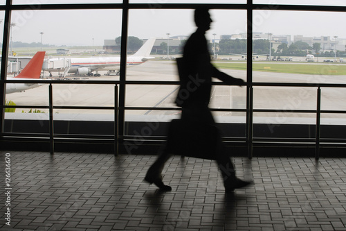 Free Download Man walking in airport - GFXLoad