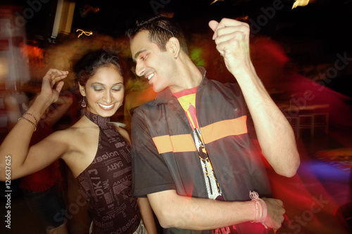 Couple dancing in night club