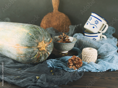 Thanksgiving mood still life with pumpkin on dark background photo