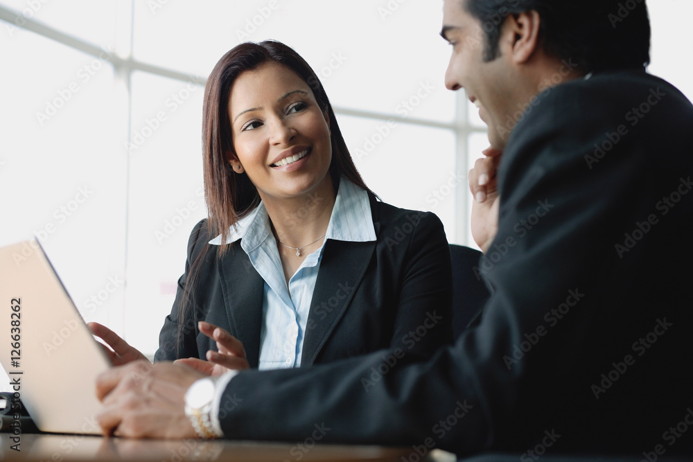 Businesswoman and businessman using laptop Businesswoman and businessman using laptop