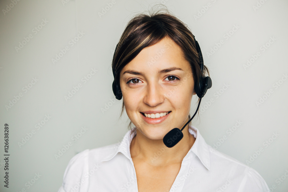 Closeup of a beautiful business customer service woman smiling Closeup of a beautiful business customer service woman smiling