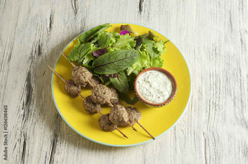 Keftedes, greek veal meatballs served with tzatziki sauce 