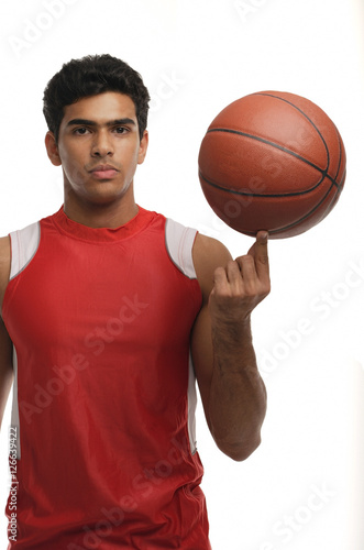 Young man with basketball looking at camera