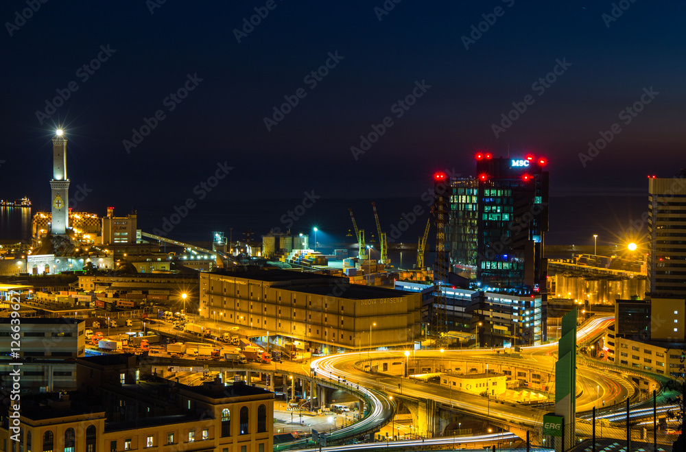 GENOA, ITALY OCTOBER 30, 2016 - Industrial area near the port with Lanterna and commercial skyscrapers at night