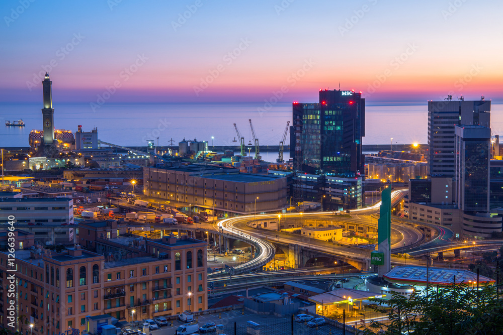 GENOA, ITALY OCTOBER 30, 2016 - Industrial area near the port with Lanterna and commercial skyscrapers at sunset