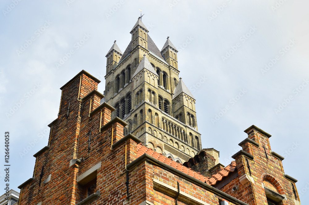 brugges traditional facade and church tower