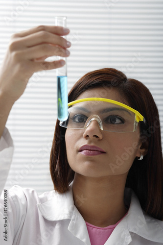 Tablou pe pânză Scientist with vile of liquid