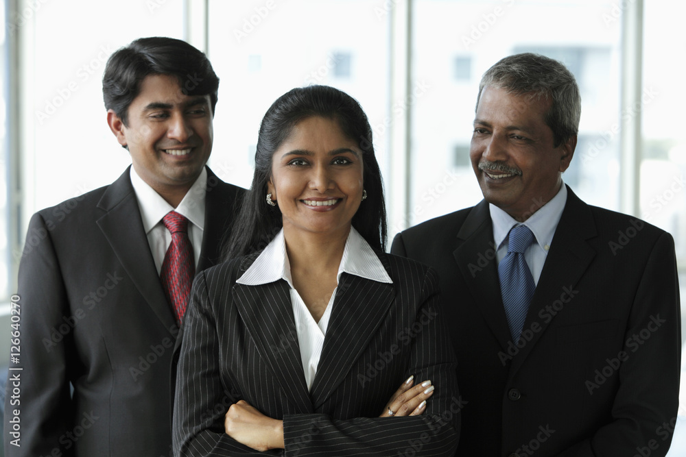 Two business men looking at their female colleague Two business men looking at their female colleague