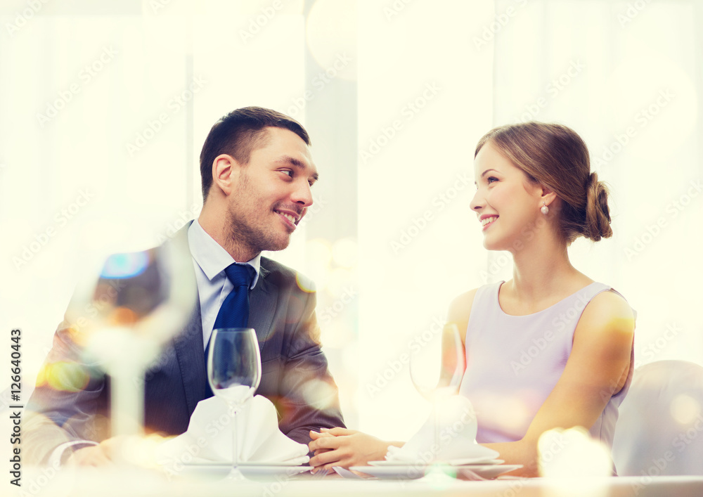smiling couple looking at each other at restaurant smiling couple looking at each other at restaurant