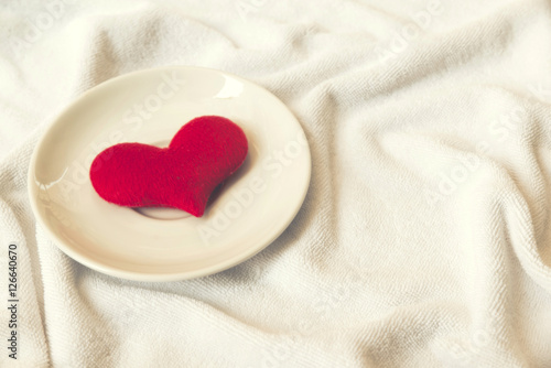 red heart in dish on towel white floor love concept