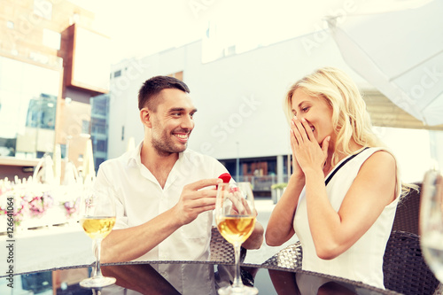 man with engagement ring making proposal to woman