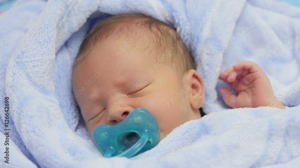 Newborn baby in blanket.
Newborn baby in blanket.