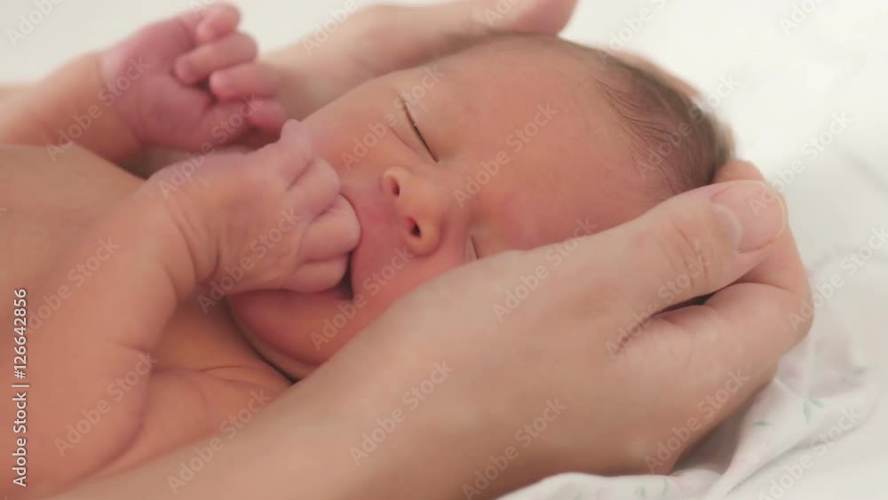 Mother caresses the newborn.
Mother caresses the newborn.